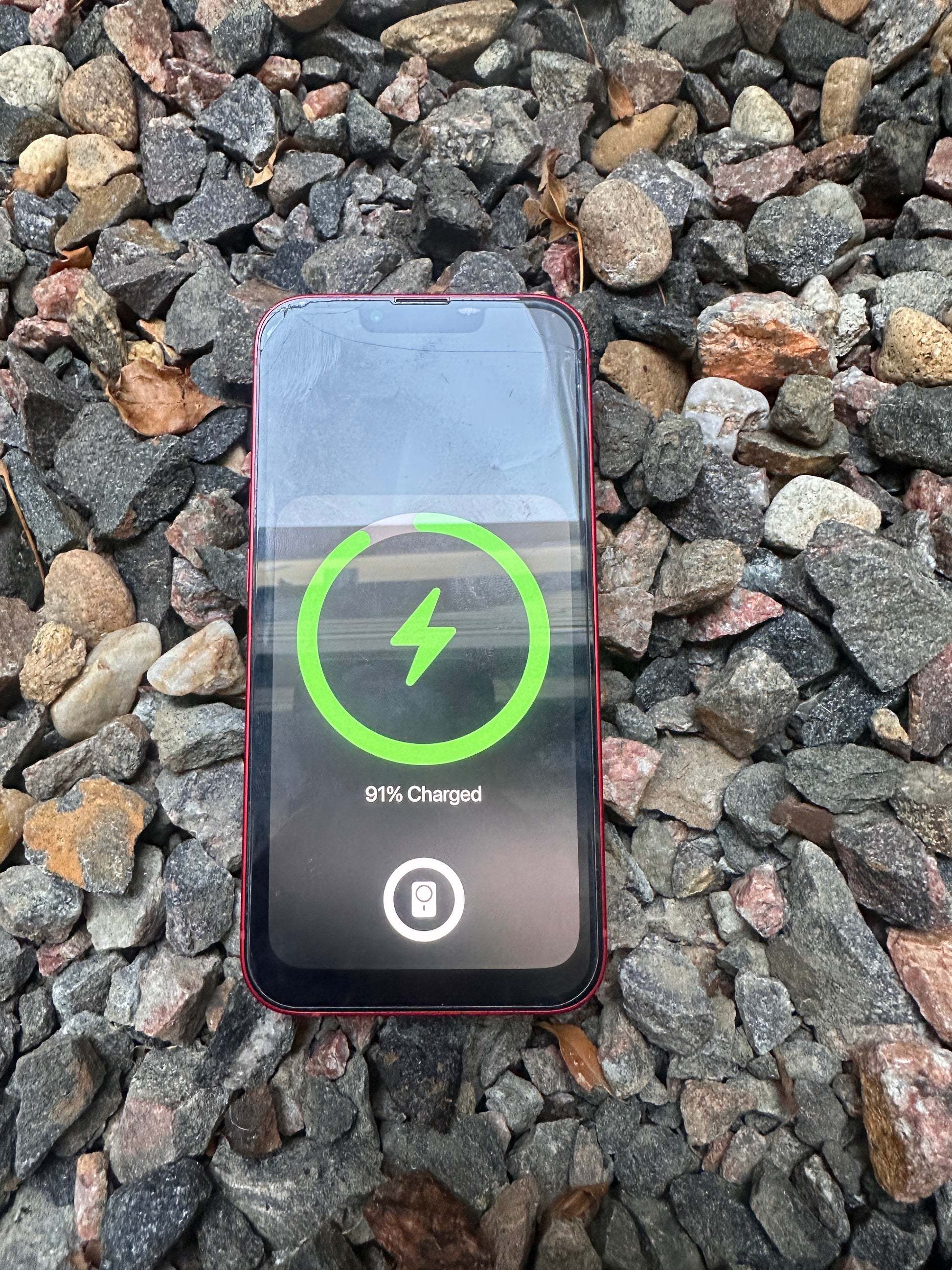 Slim profile magnetic wireless charger V2 charging a phone through case
